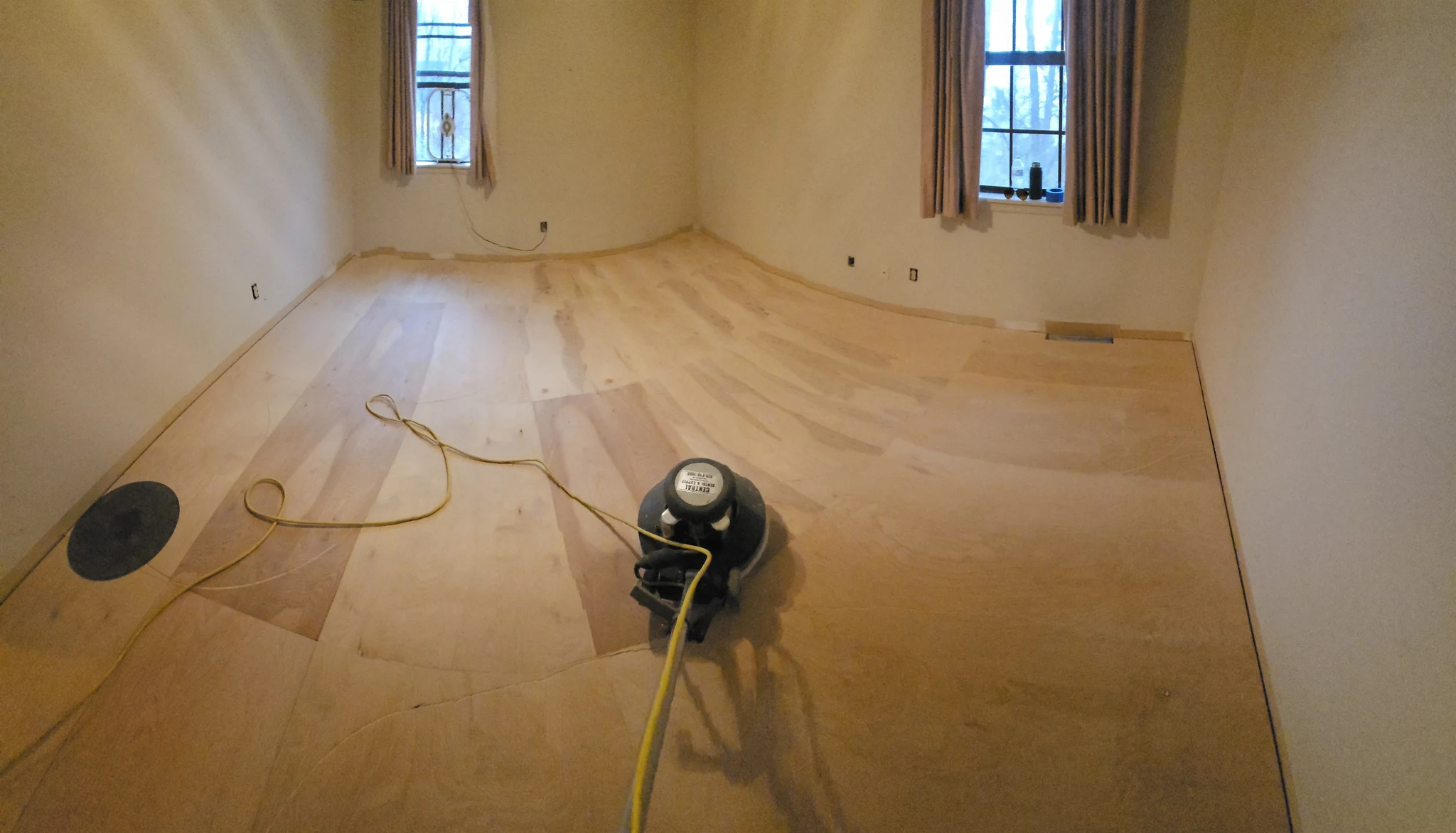 The birch floor laid across the room with light coming in from the windows.