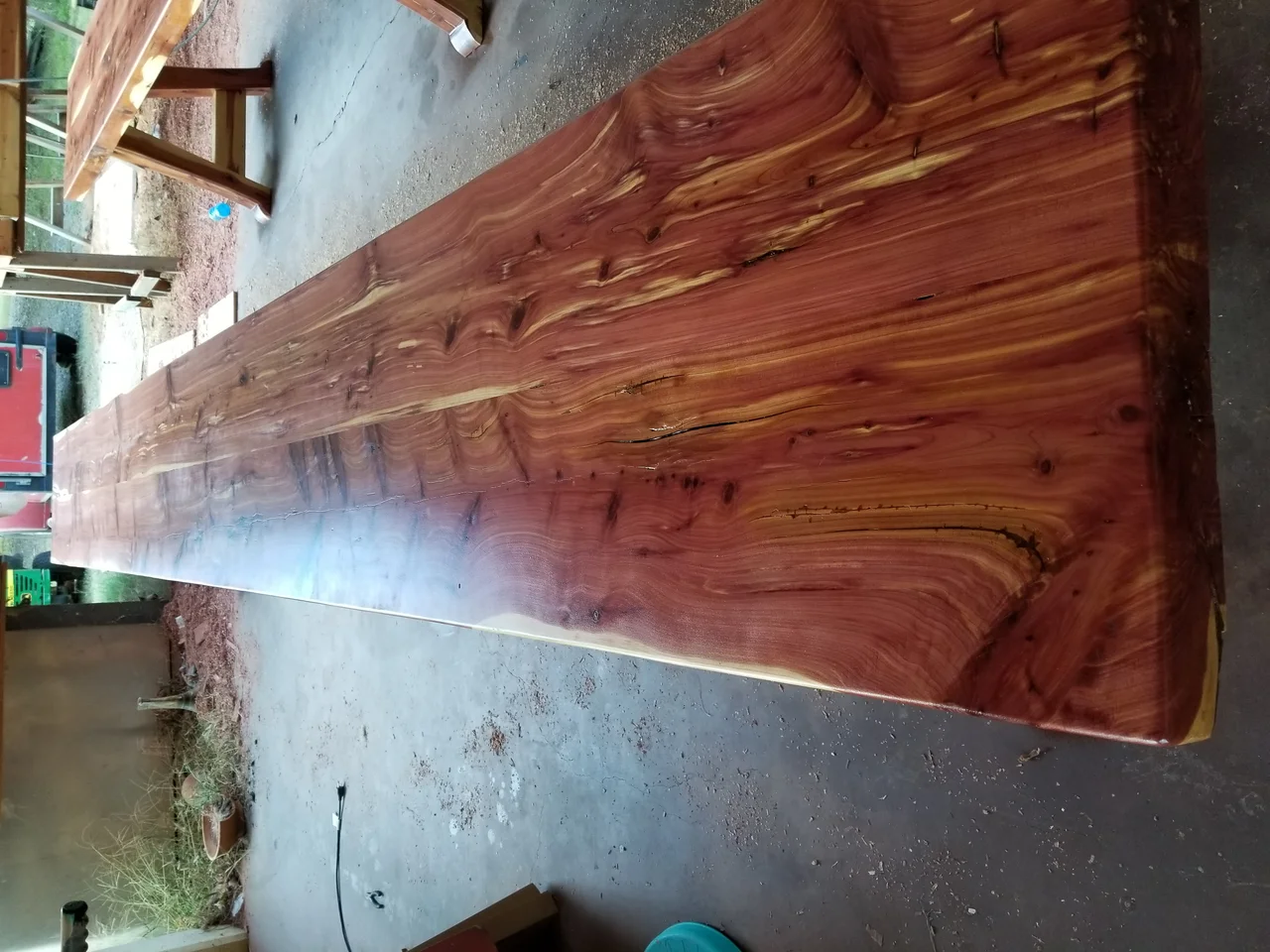 The finished cedar tables and benches lined up in the shop.