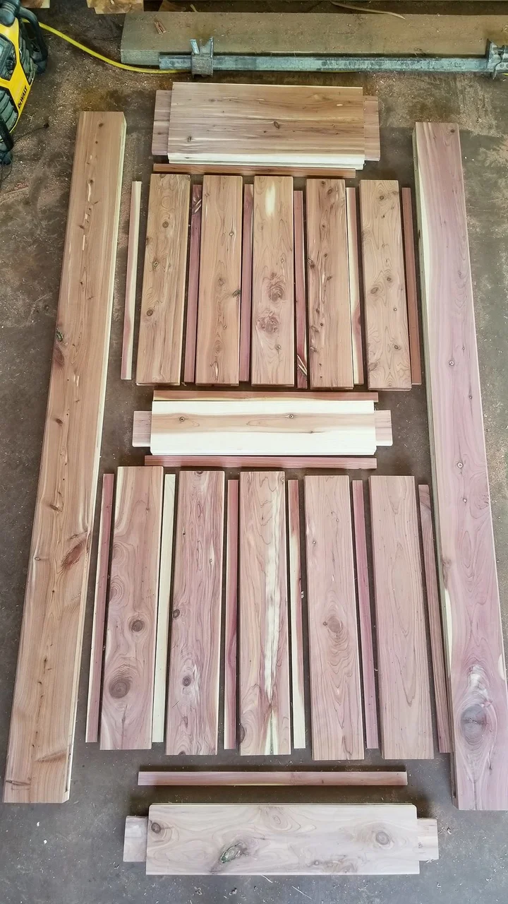 Cedar door parts laid out on the shop floor before assembly.