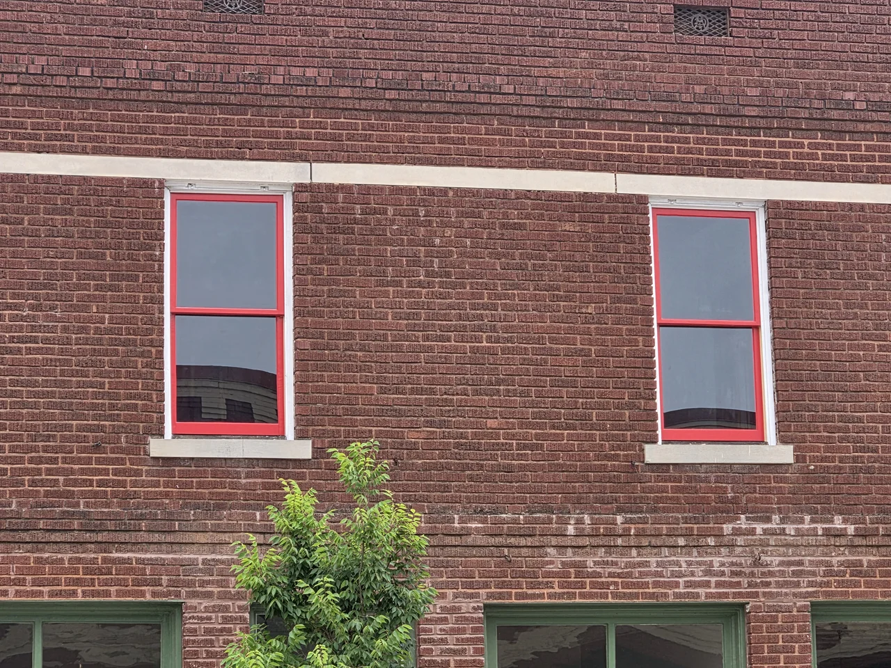 The building interior with bare plaster walls and the window openings stripped out.