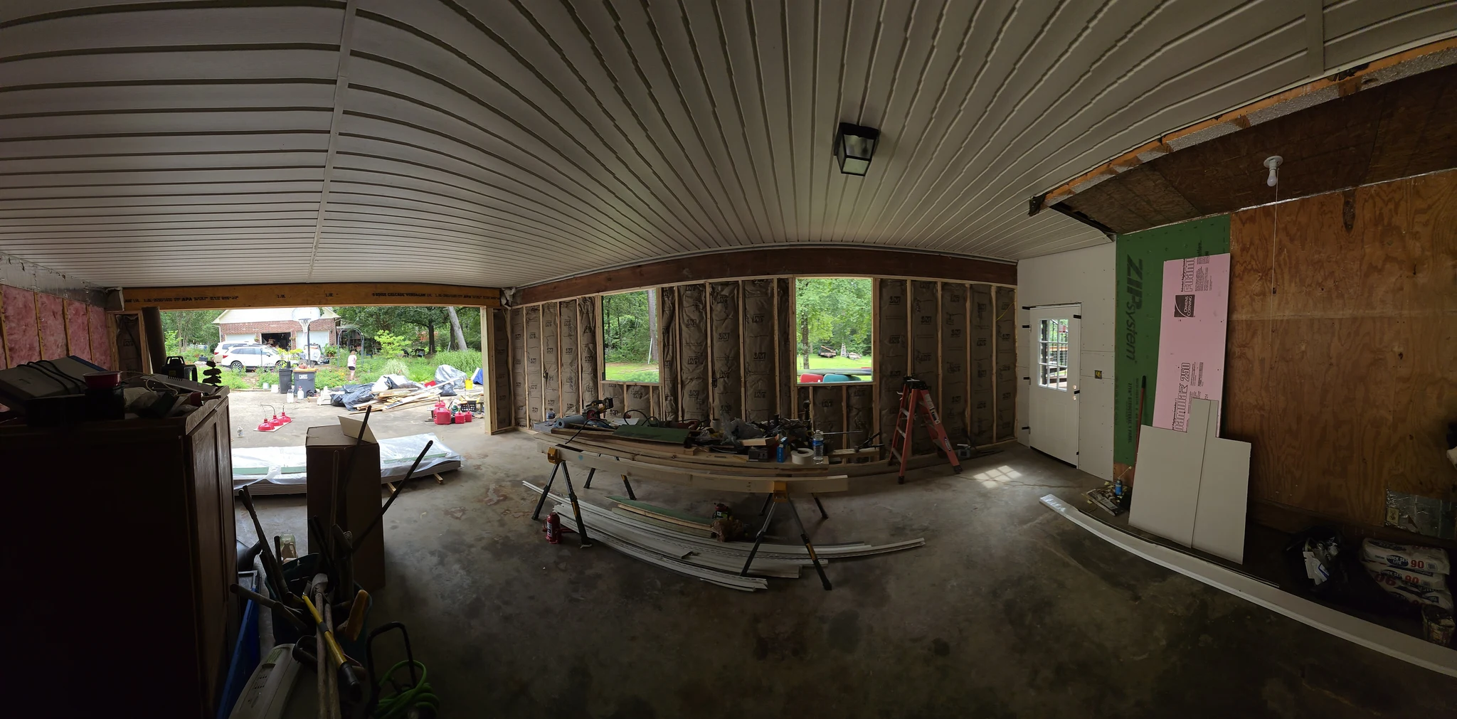 Wide interior view showing the metal ceiling and new framing.