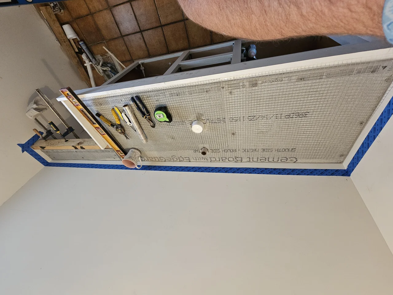 Cement board formwork built for casting a concrete countertop in place.