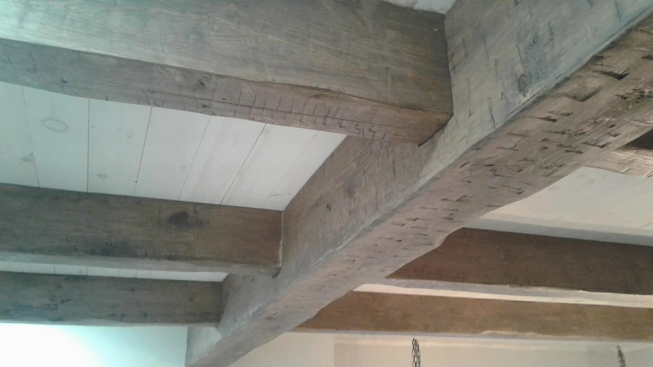 A rough-sawn beamed ceiling assembly.