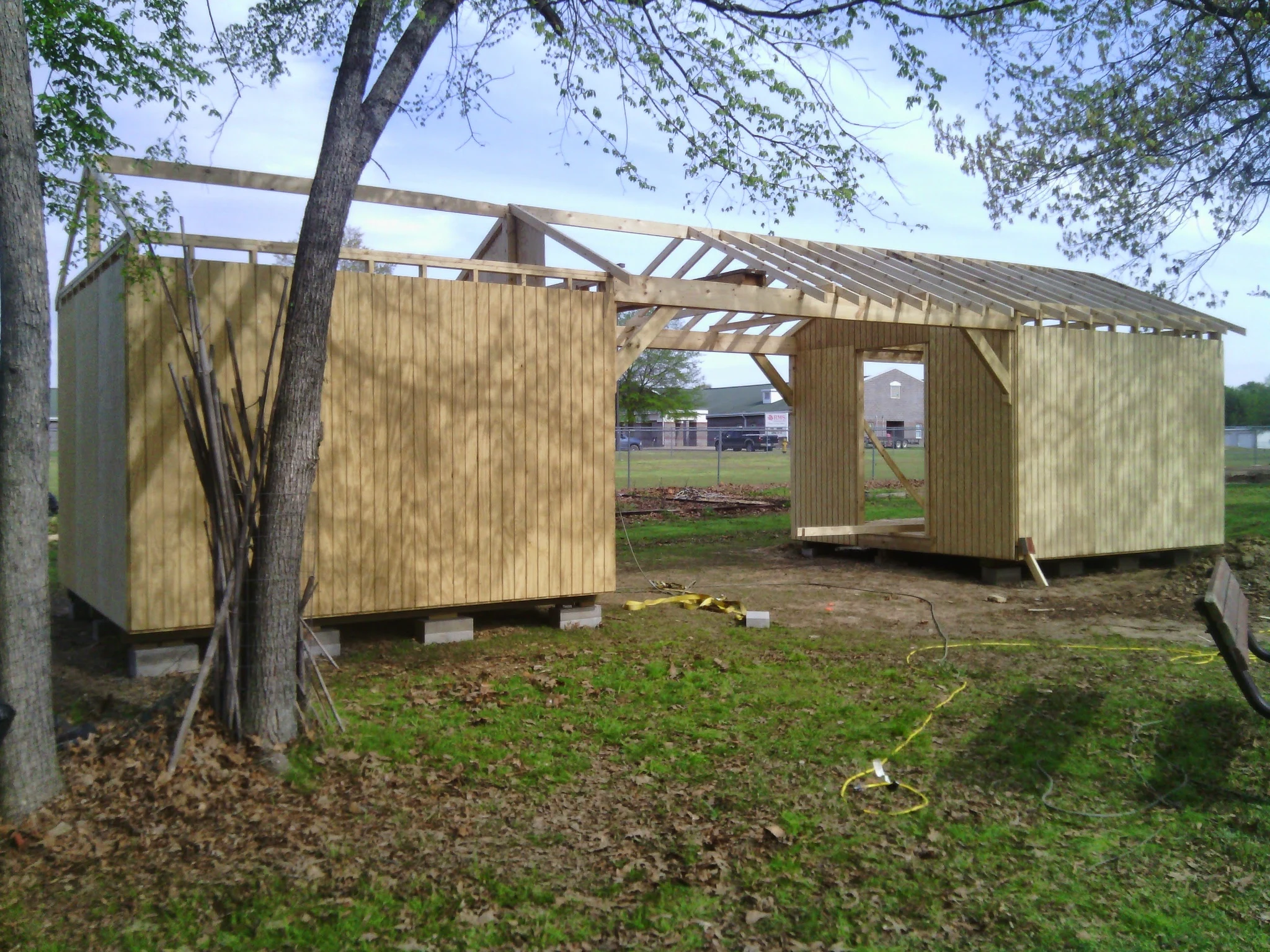 The structure sheathed with roof trusses being installed.