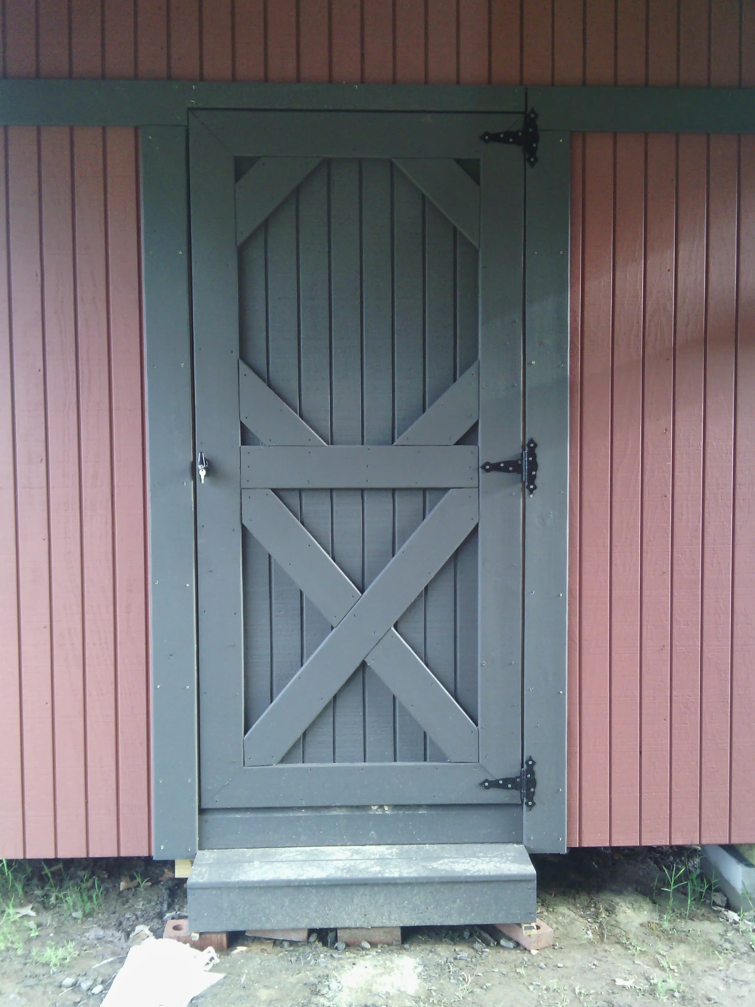Detail of an X-braced batten door with strap hinges.