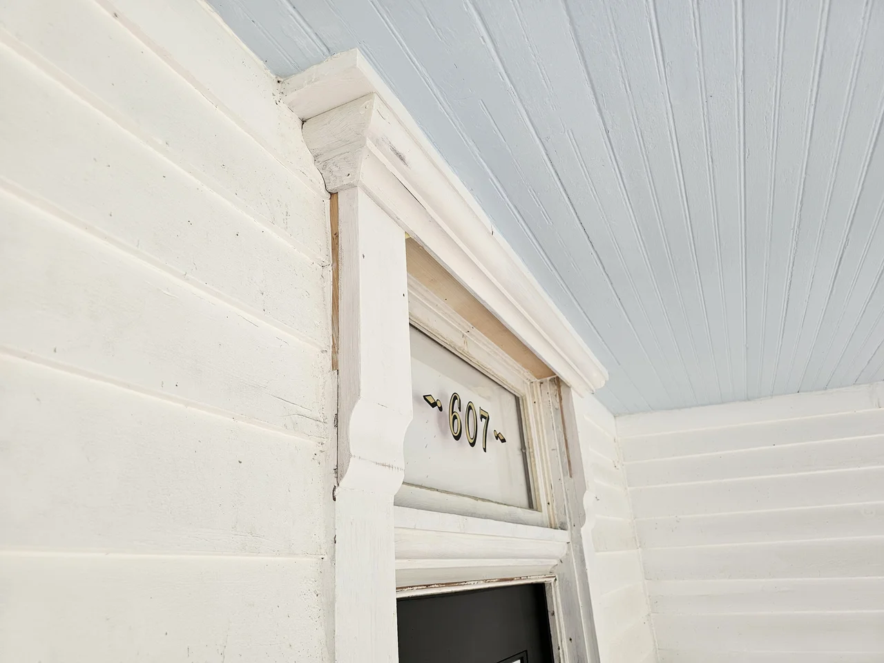 The restored transom above the door, glazed with the house numbers.