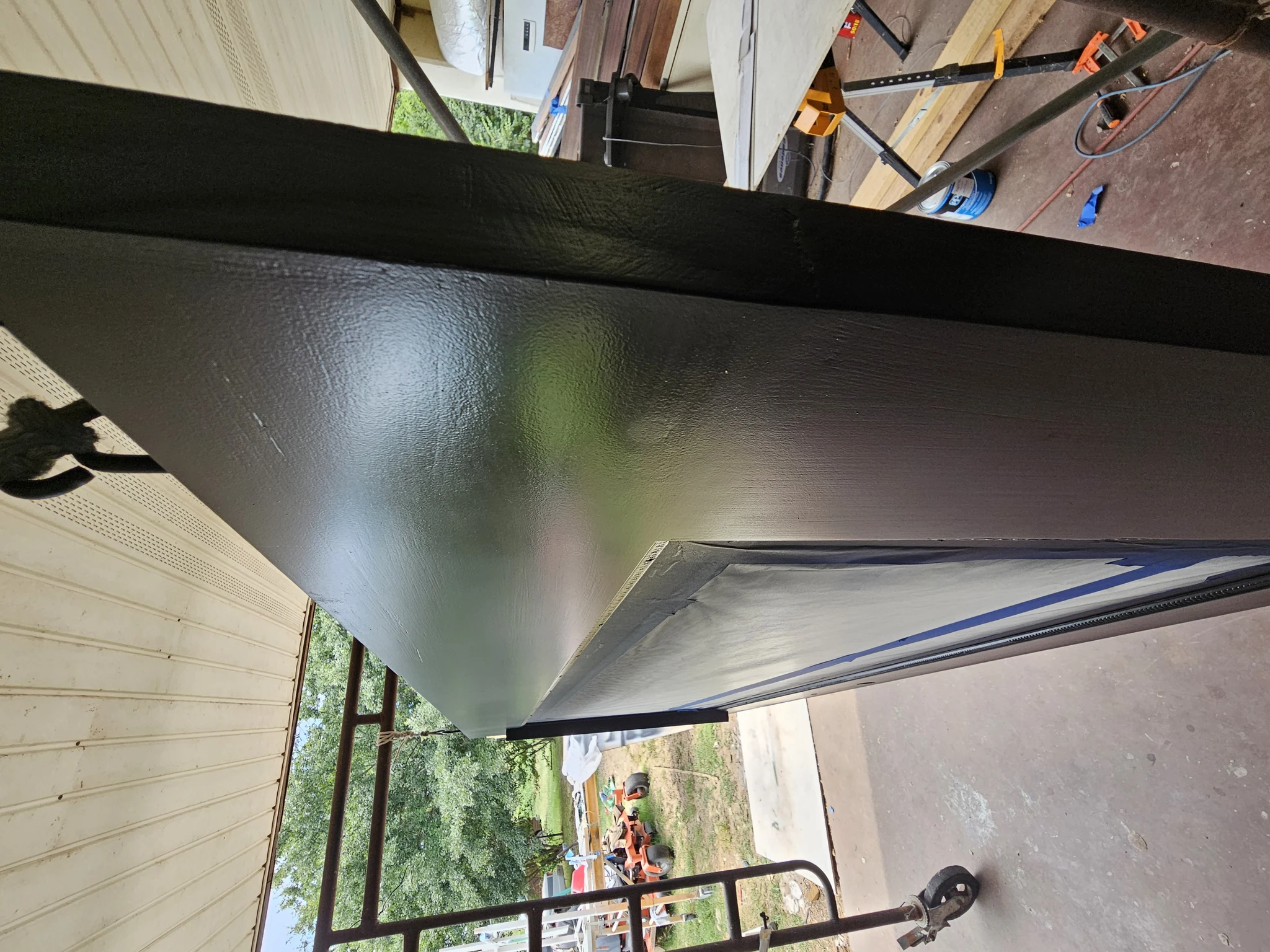 The finished entry door standing on edge in the shop.