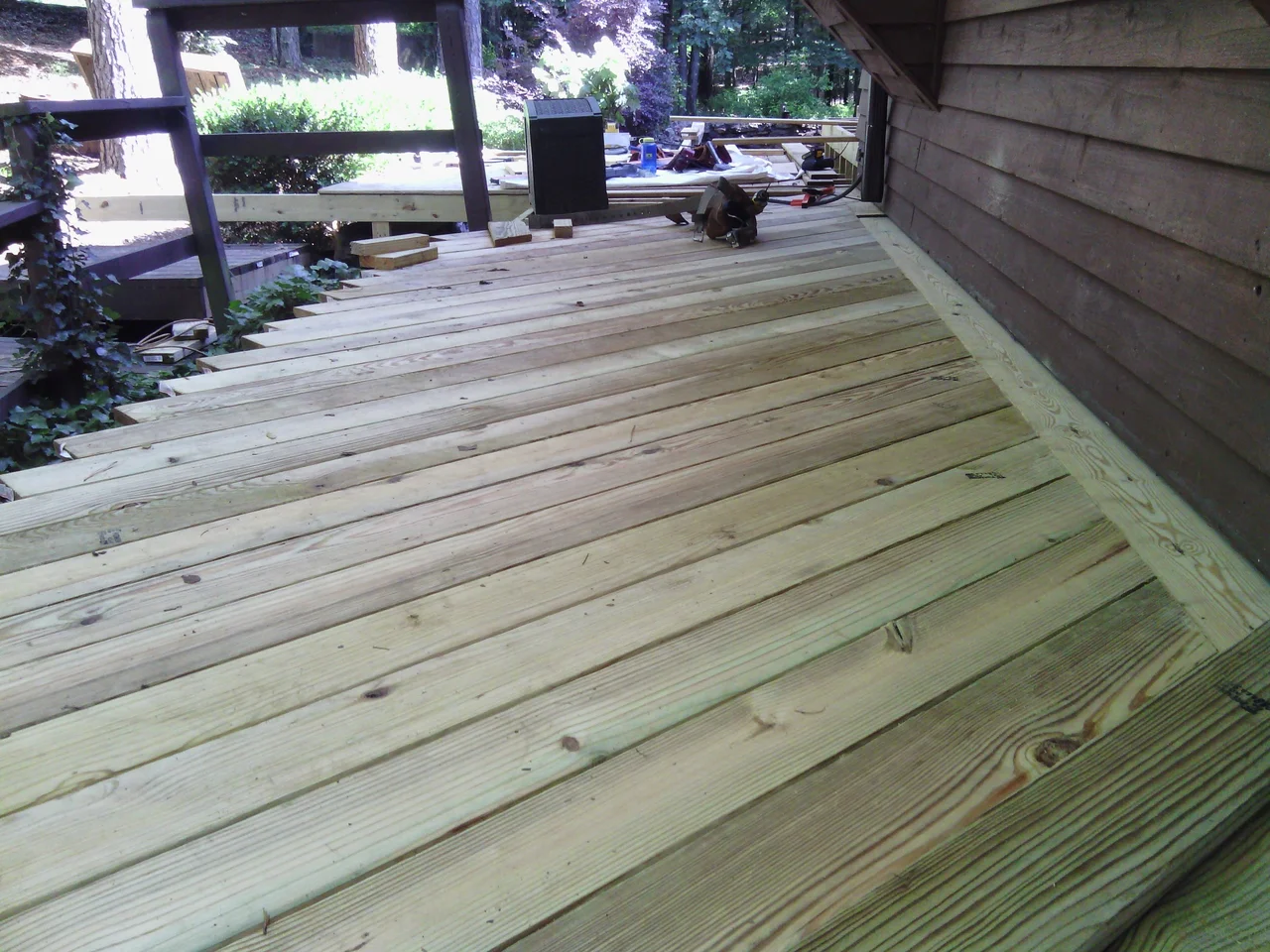 The deck sweeping around the canted bay of the house.