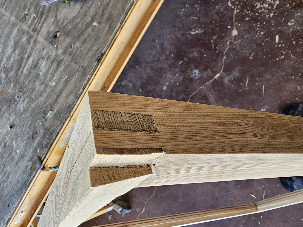 An open mortise-and-tenon joint at the head of a window frame, haunch visible.