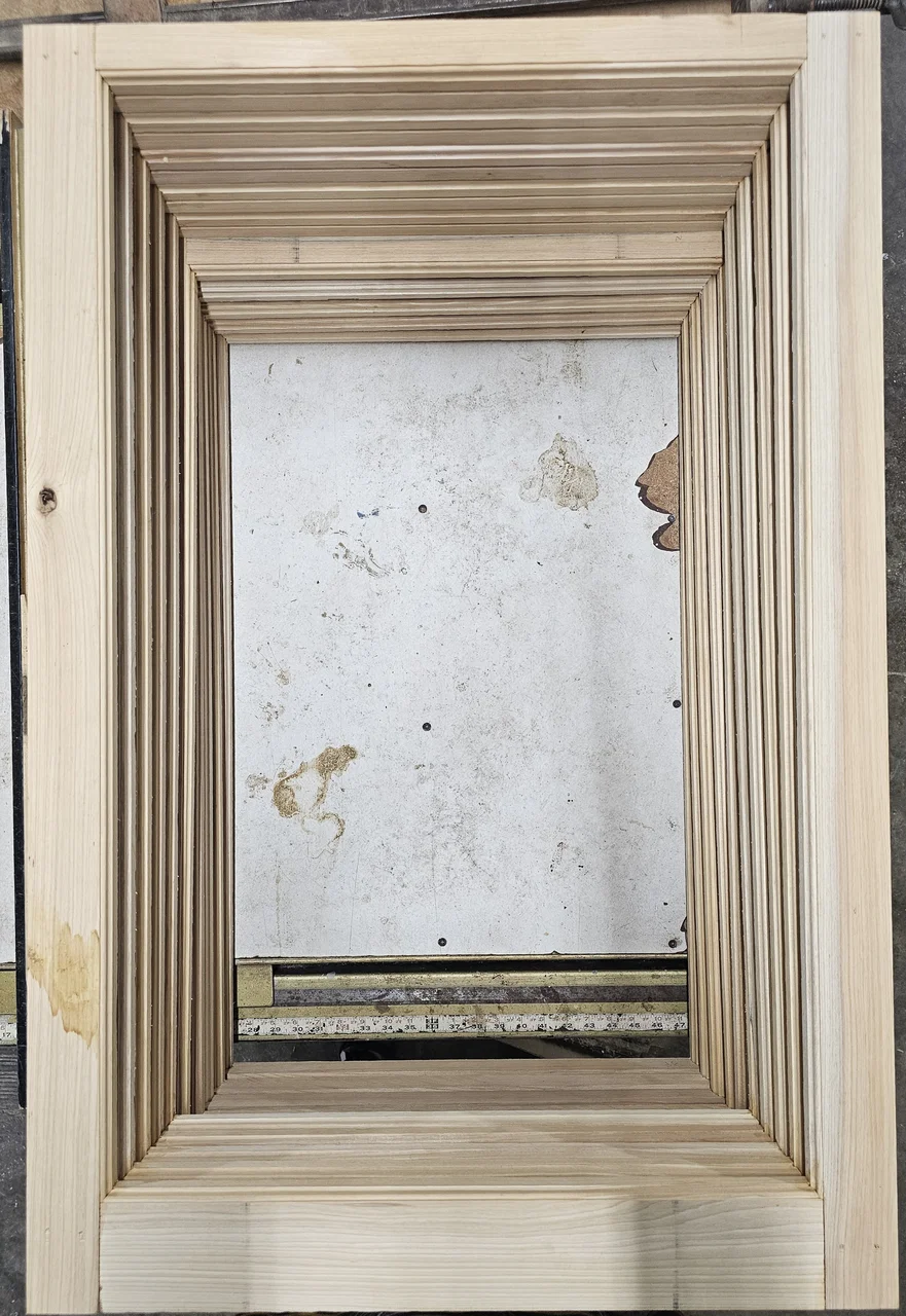 A built-up molded architrave assembled from several separately milled profiles.