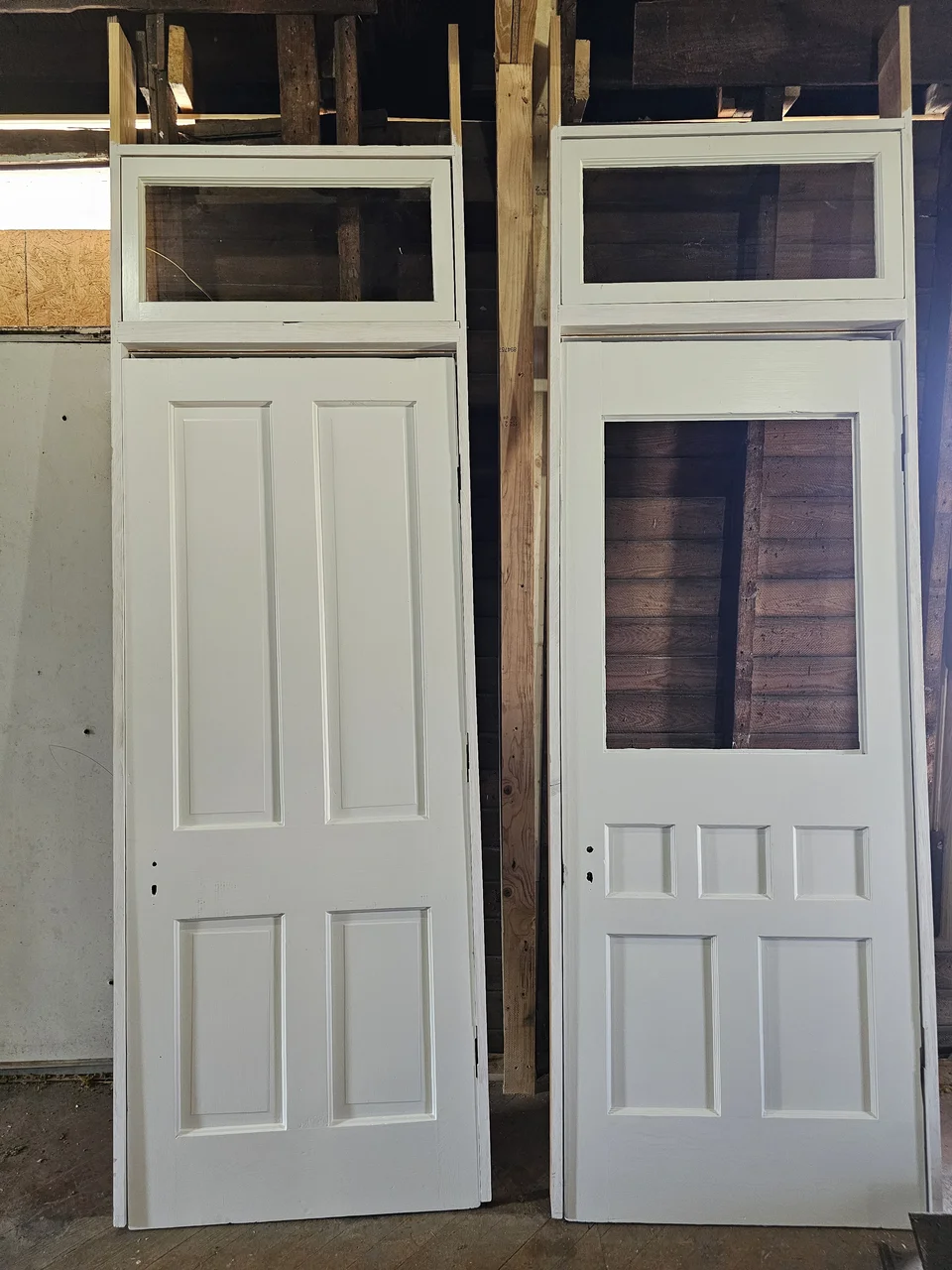 Two original panelled doors standing restored and painted.