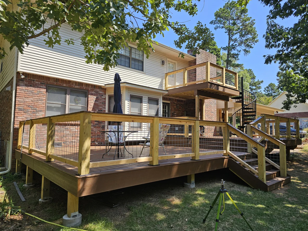 The finished deck with table, chairs and umbrella in use.