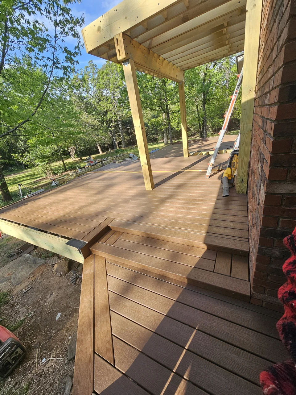 The finished deck boards running beneath the covered section.
