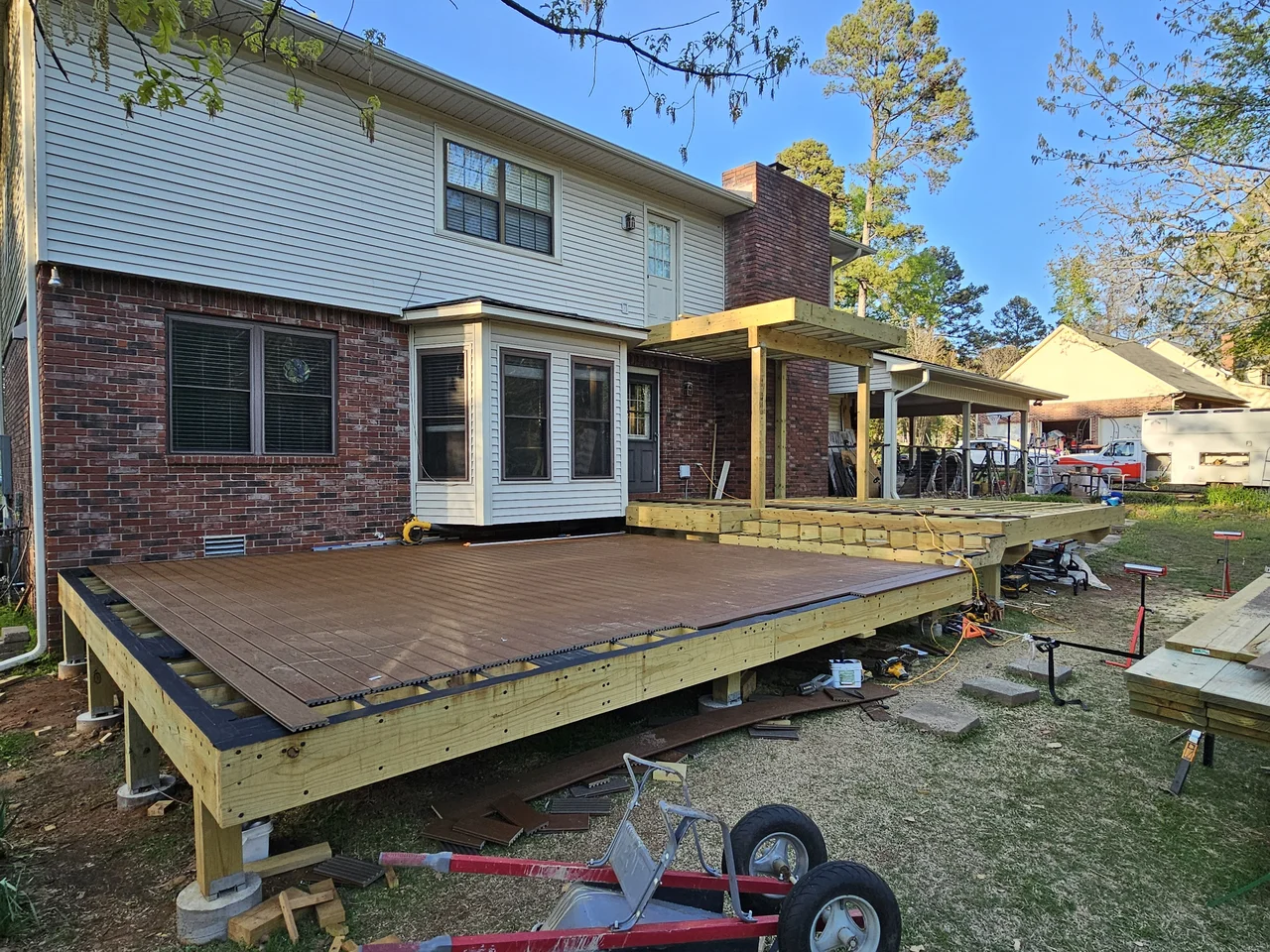 Wide view of the deck with boards laid and structure still visible below.