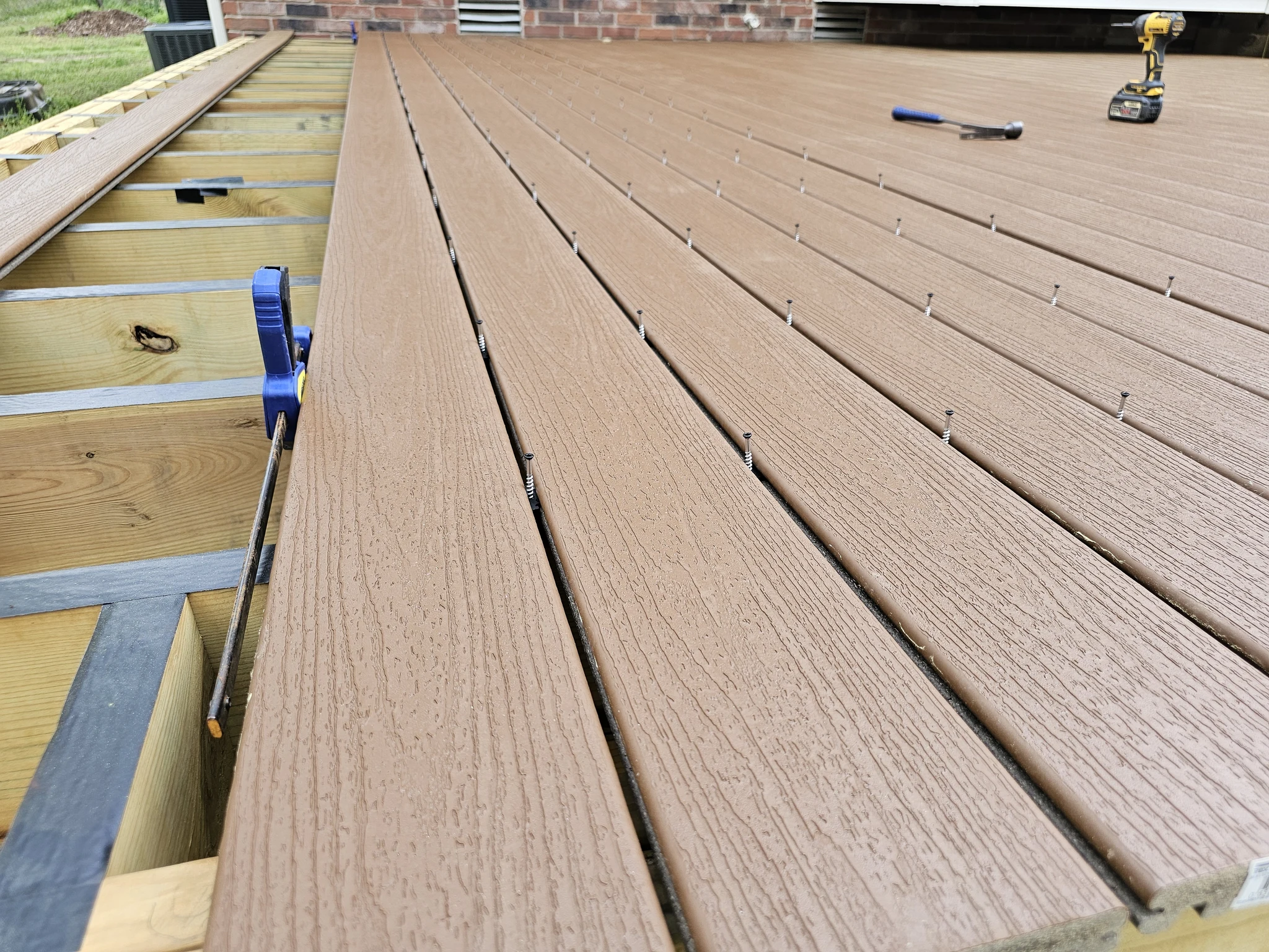 A run of composite decking boards showing hidden fastener installation.