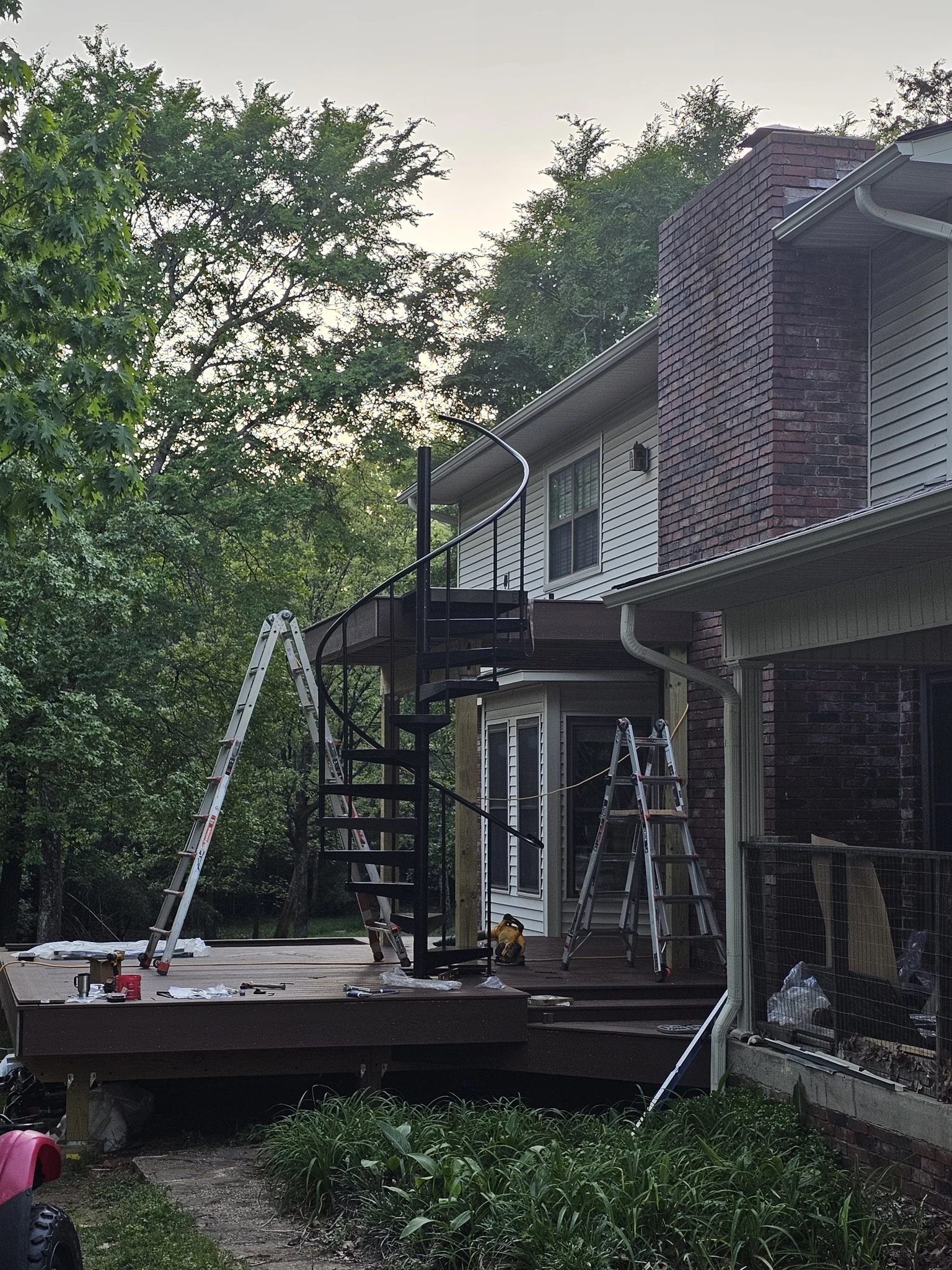 The stair and both deck levels seen from the lawn with the handrail in place.