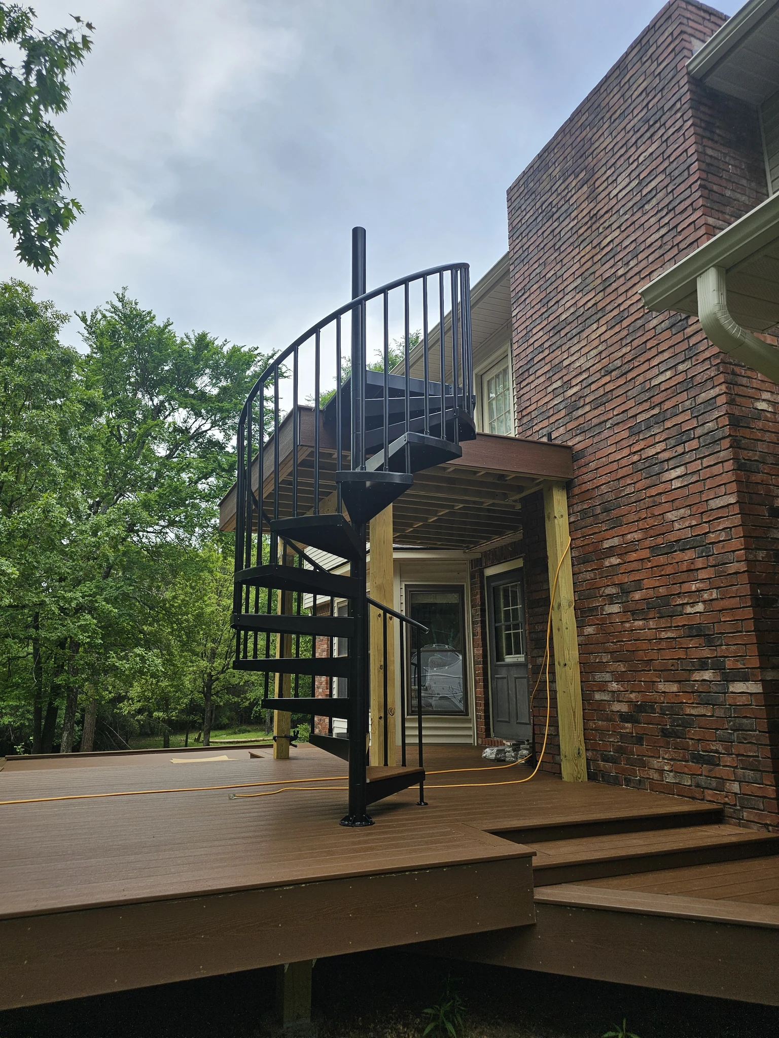 The completed spiral stair on a clear deck with no tools or materials remaining.