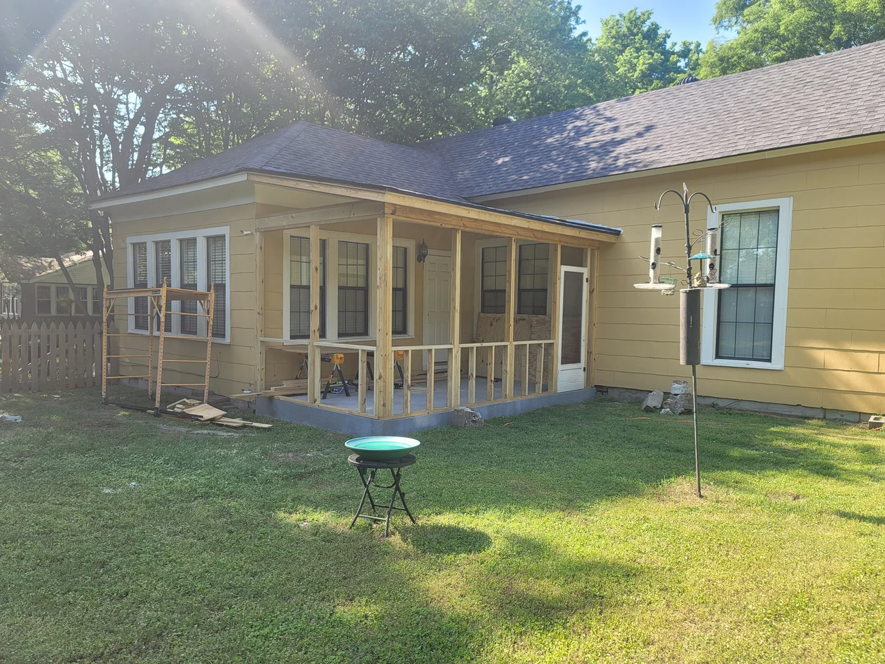 The porch structure framed out with posts and roof structure in place.