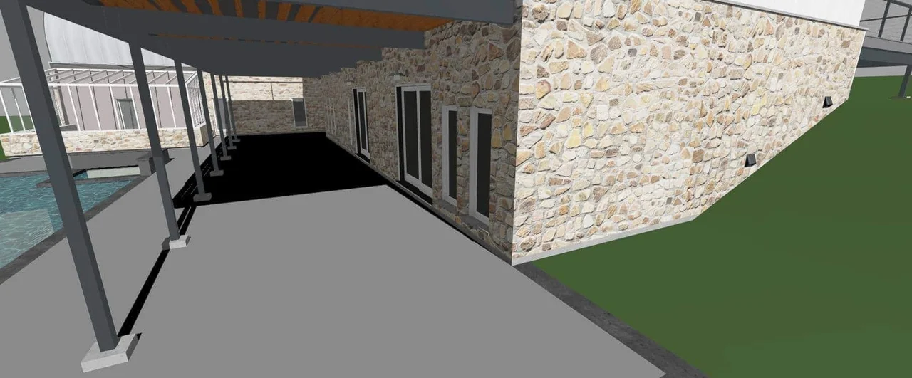 An interior rendering of the covered lower level with a pool and stone walls, shown as designed. The pool was not built.