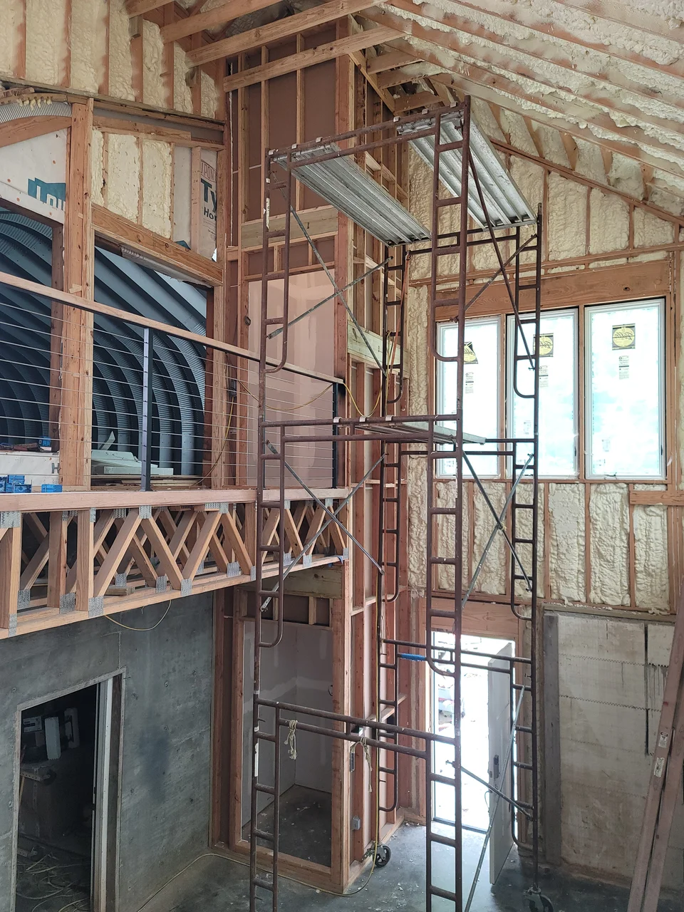 The tall entry volume with scaffolding and the stair opening beyond.