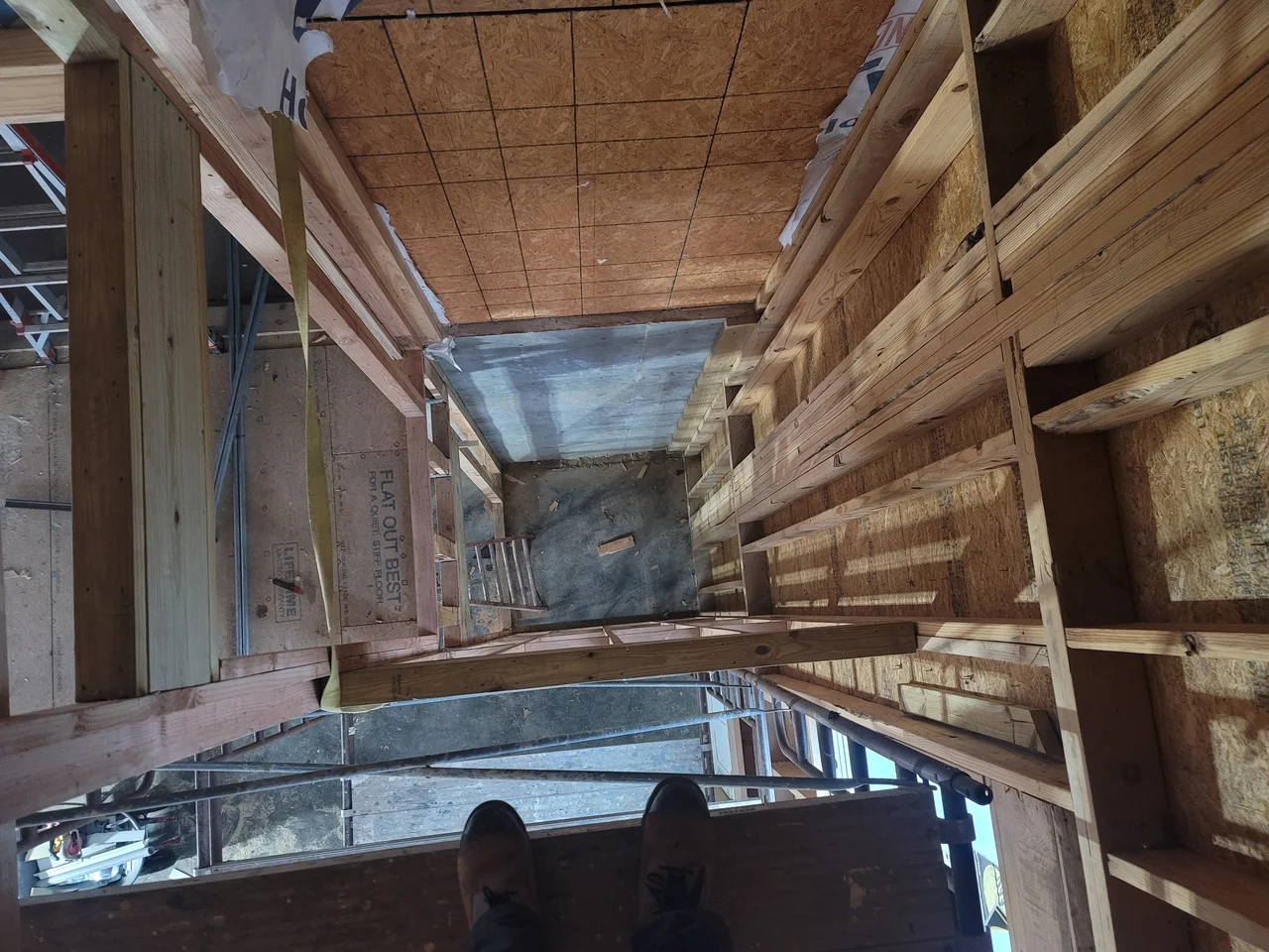 Looking up the framed elevator shaft.