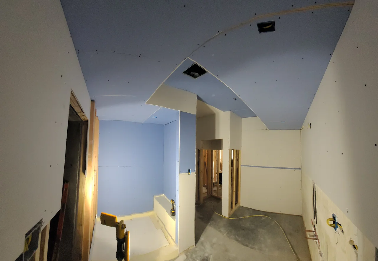 Drywall following the curve of the vaulted ceiling.
