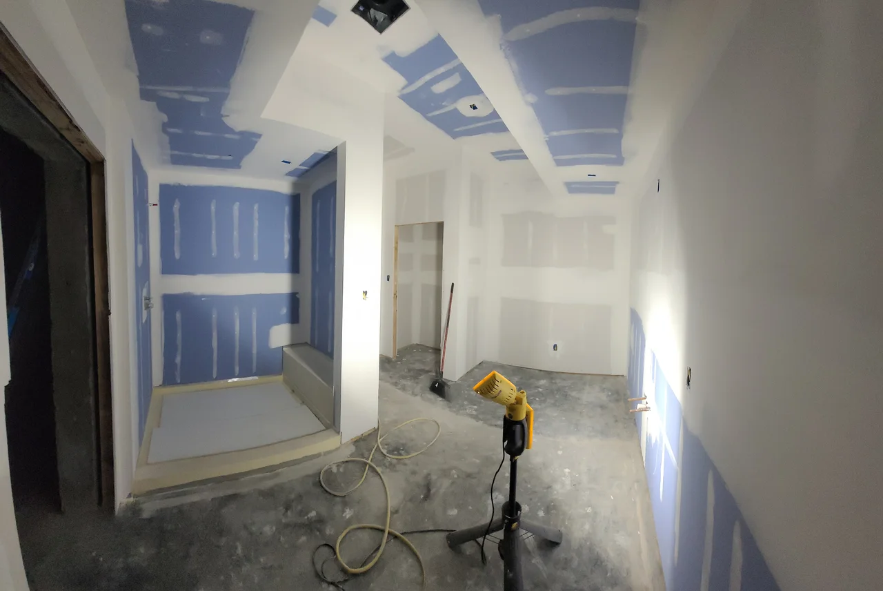 Moisture-resistant board hung and taped in the bathroom.