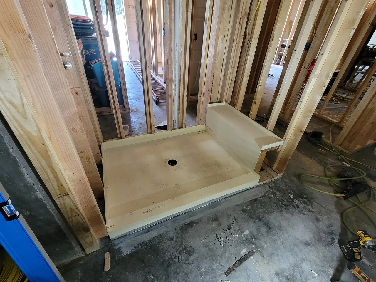 A shower pan formed in plywood and sloped to the drain.