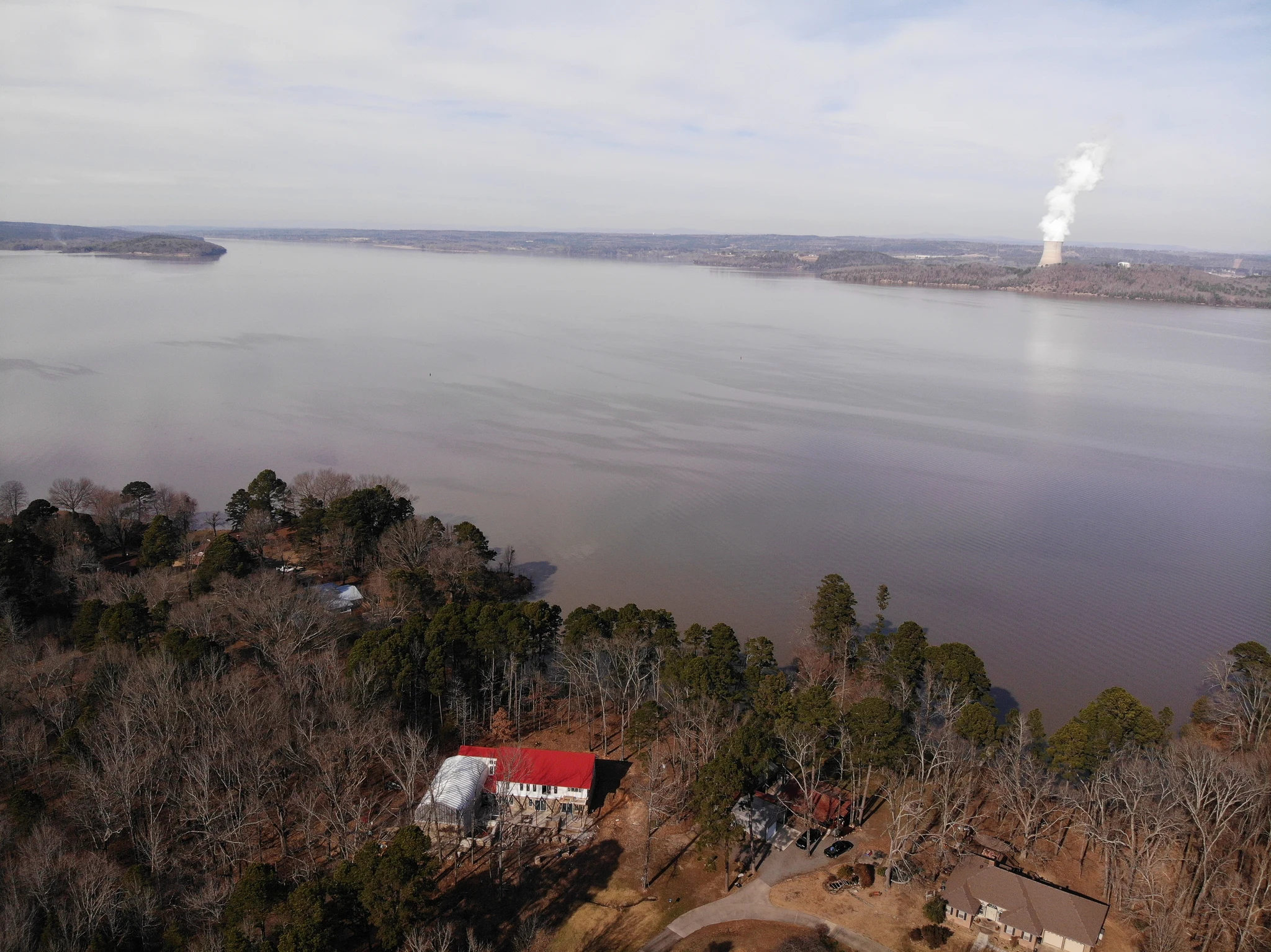 Aerial view over the lake with the house roof in the foreground.