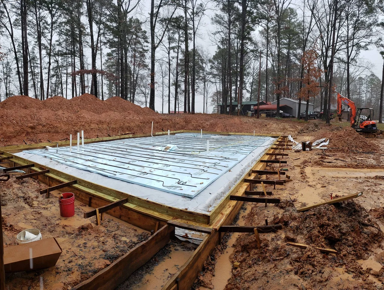 Rigid foam insulation panels set into the excavated slab area.