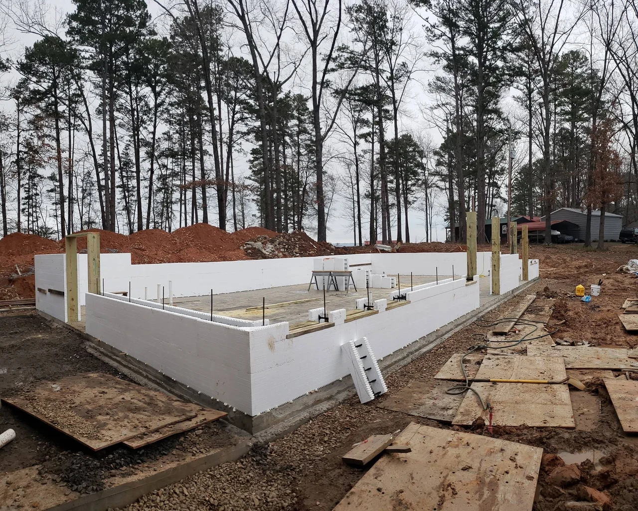 White insulated concrete form blocks stacked into basement walls.