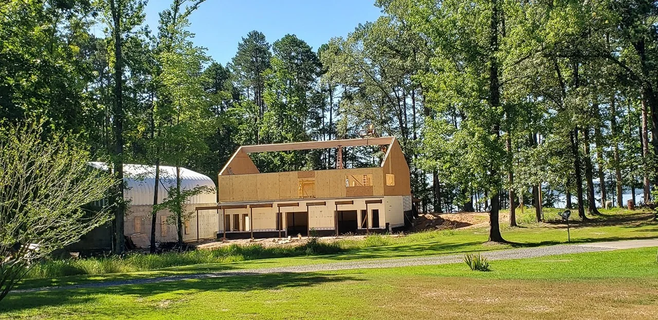 The concrete lower level with timber framing beginning above it.