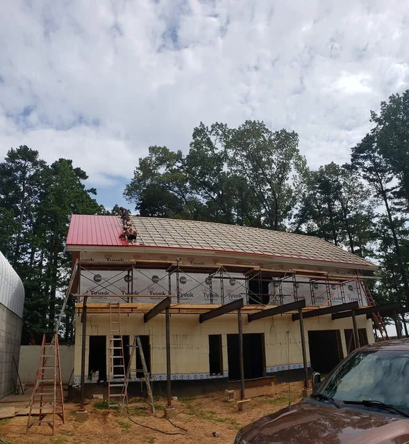 Framing above the garage deck with the arch building alongside.