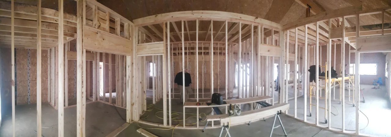 Wide interior view of the framed lower level before partitions.