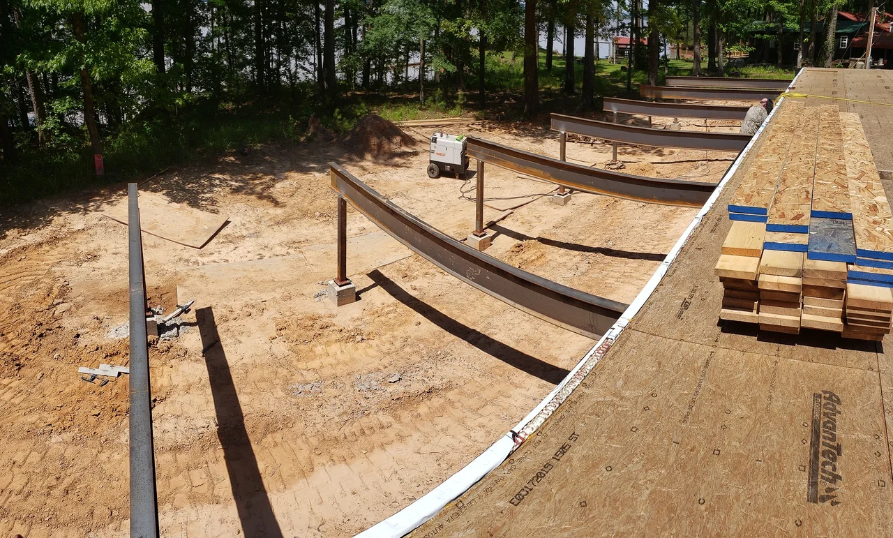 Long open-web floor trusses landed on the wall plate.