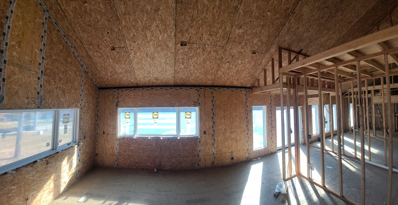 Interior sheathed walls with a band of clerestory windows.