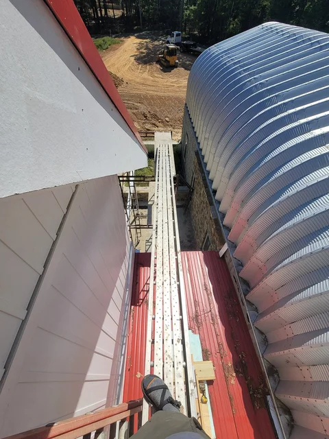 Close view along the corrugated steel ribs of the arch building.
