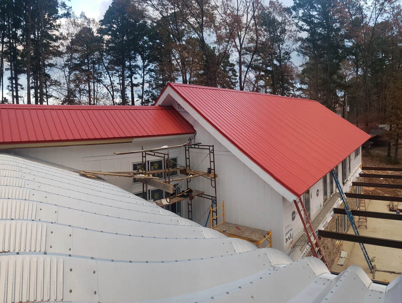 Aerial view of the arch building and red roof from overhead.