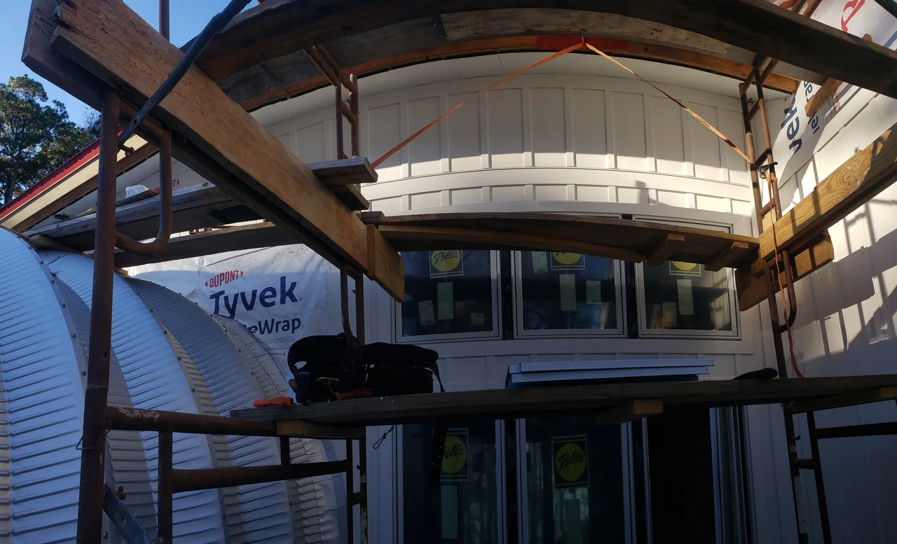 Looking up under the arch to the window wall, scaffolding in place.