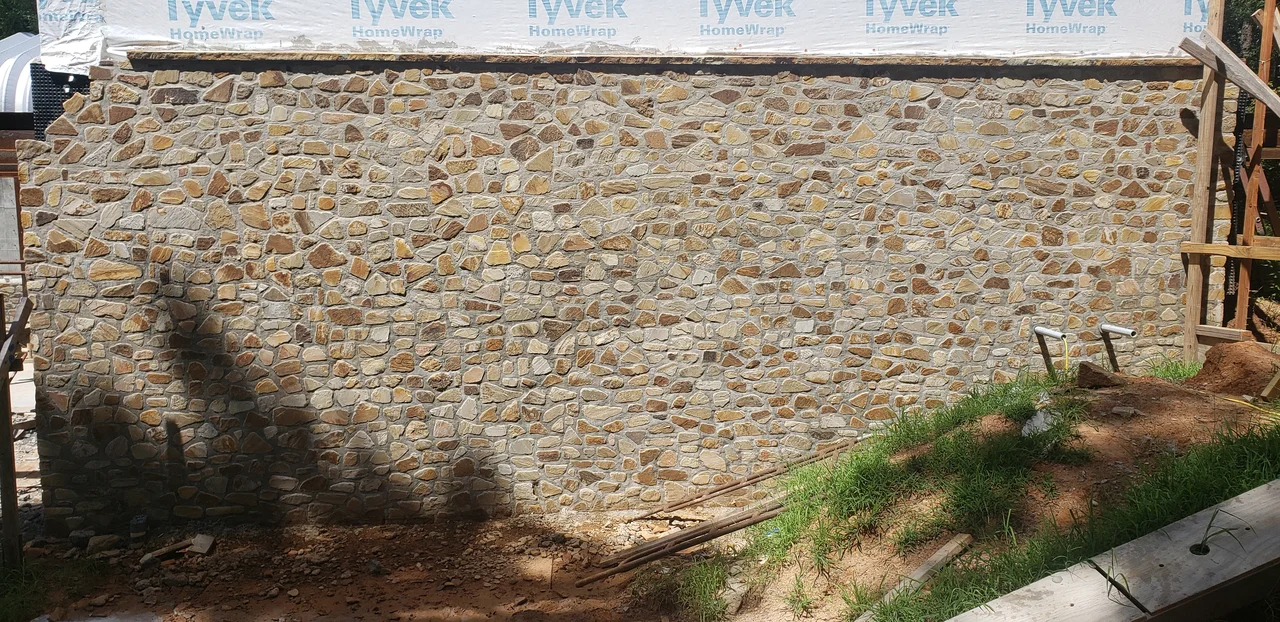 A long flat expanse of finished stone wall.