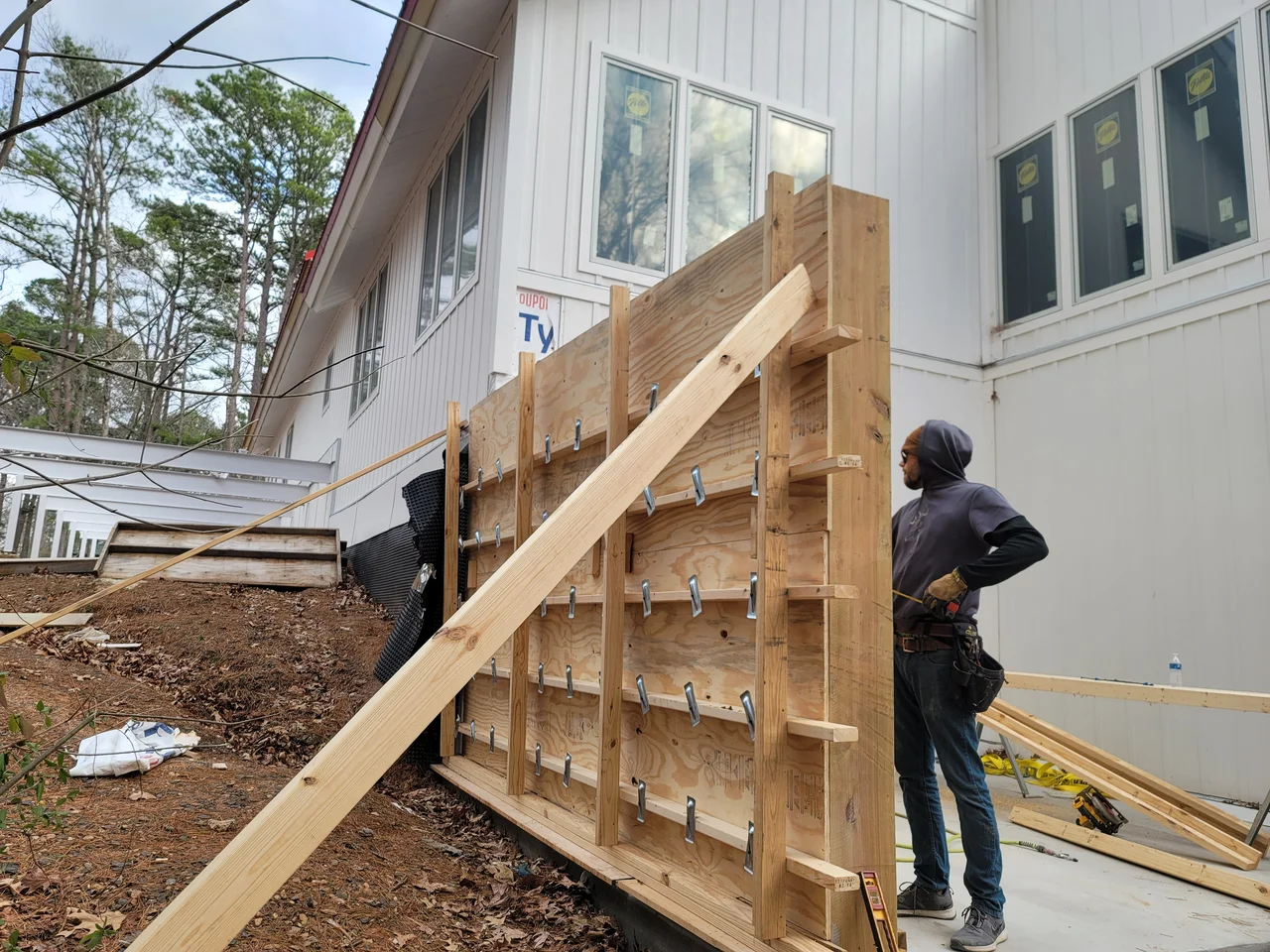 Plywood wall forms braced back with timber shoring.