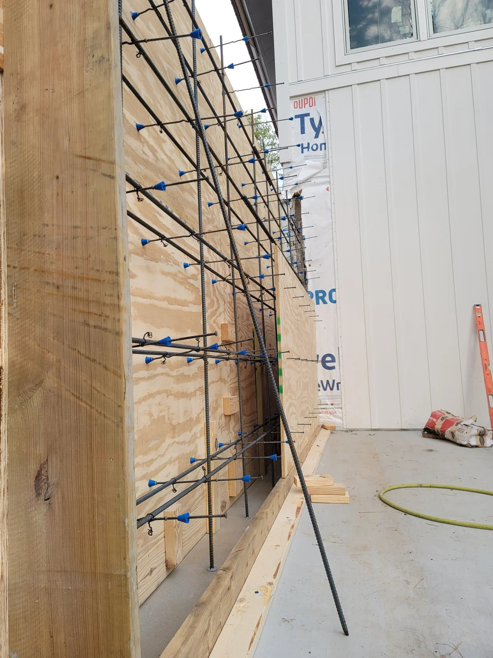 Reinforcing steel set inside braced wall formwork.