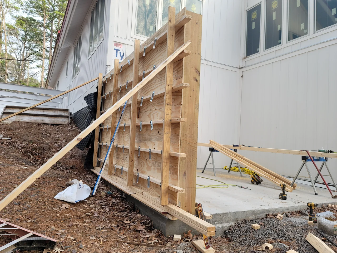Completed wall formwork with rebar, braced and ready for concrete.