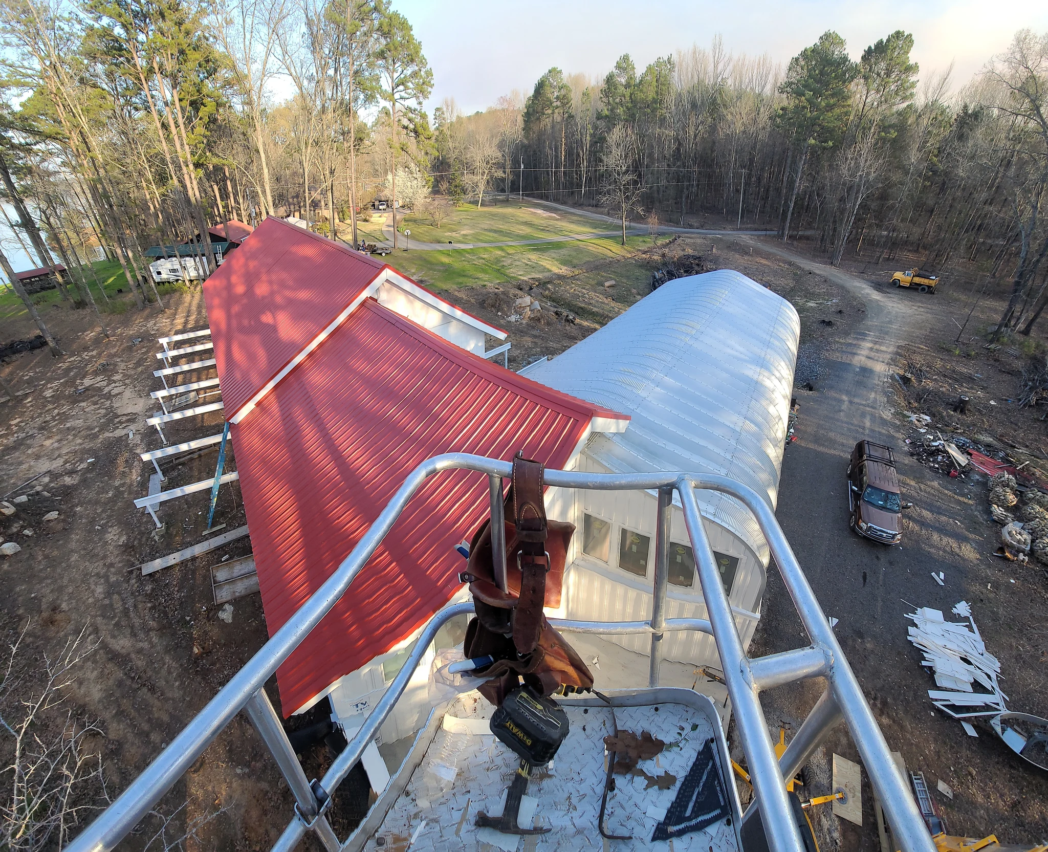 Aerial view of the red standing-seam roof meeting the arch building.