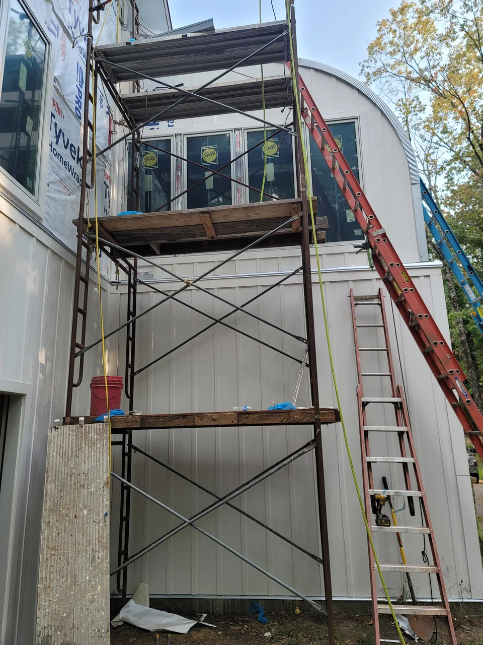 Siding going up from scaffolding on the gable end.