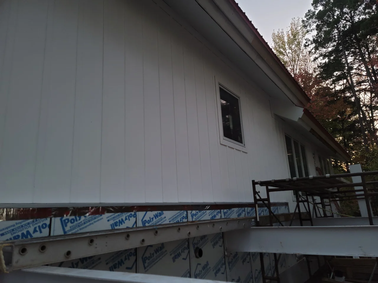 Looking up at the eave, siding and window head detail.