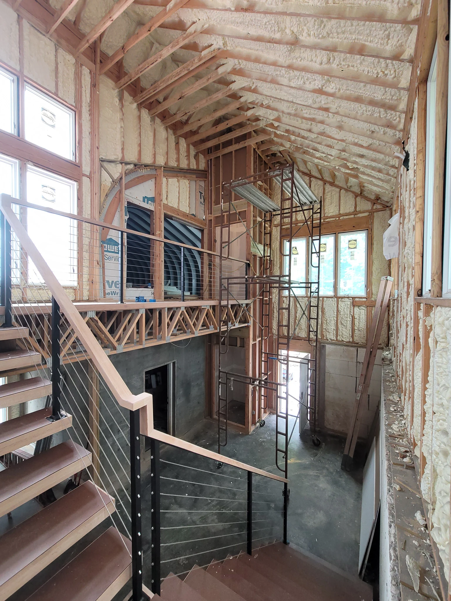 The floating stair seen within the full-height framed entry.