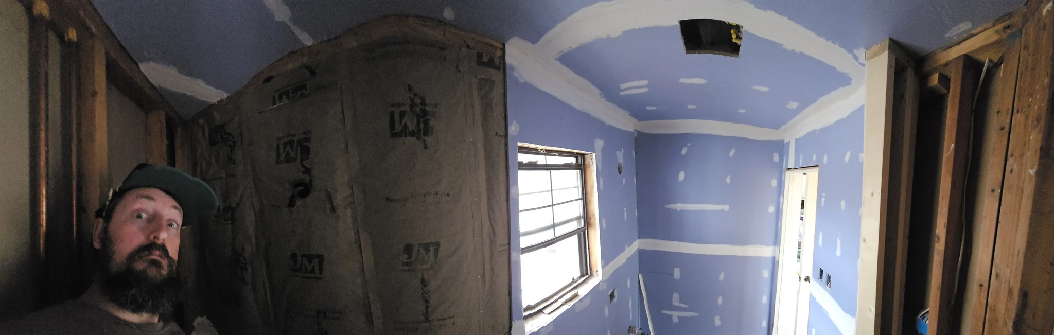 The bathroom with moisture-resistant board hung and the ceiling framed above.
