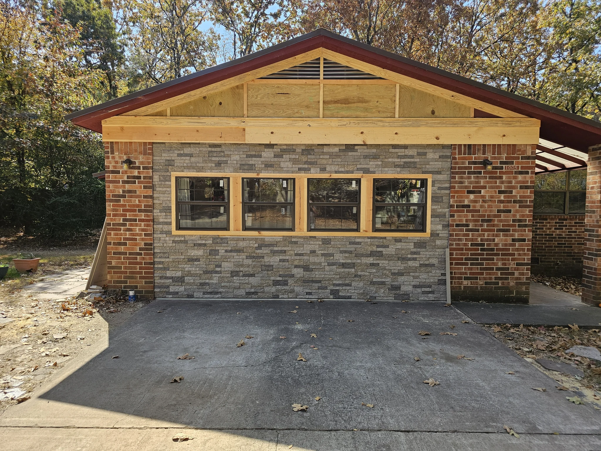 The completed elevation: stone veneer wainscot, brick and the gable above.