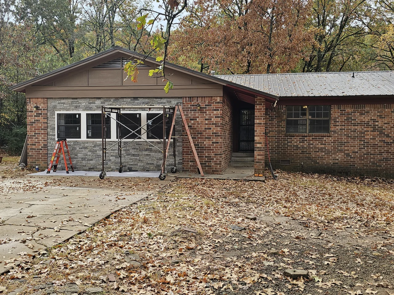 A wider view of the finished exterior including the garage bay.